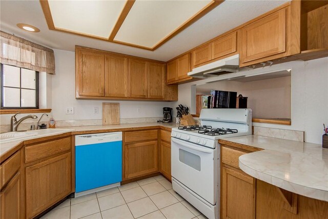6045 S Klamath Loop, Fort Mohave, AZ 86426 - kitchen with gas range gas stove, dishwasher, a sink, under cabinet range hood, and light countertops