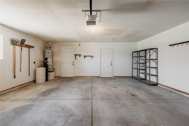 6045 S Klamath Loop, Fort Mohave, AZ 86426 - garage featuring a garage door opener, water heater, and baseboards