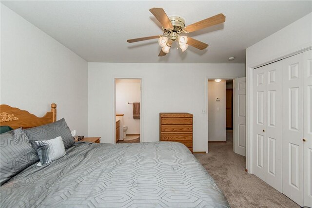 6045 S Klamath Loop, Fort Mohave, AZ 86426 - bedroom featuring light colored carpet, a closet, ceiling fan, and ensuite bathroom