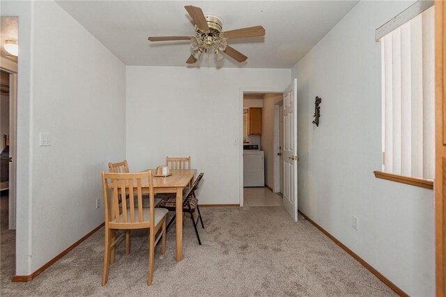 6045 S Klamath Loop, Fort Mohave, AZ 86426 - dining room featuring washer / dryer, ceiling fan, light carpet, and baseboards