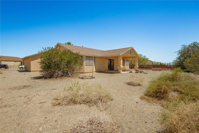 6045 S Klamath Loop, Fort Mohave, AZ 86426 - back of property with stucco siding, fence, and a patio