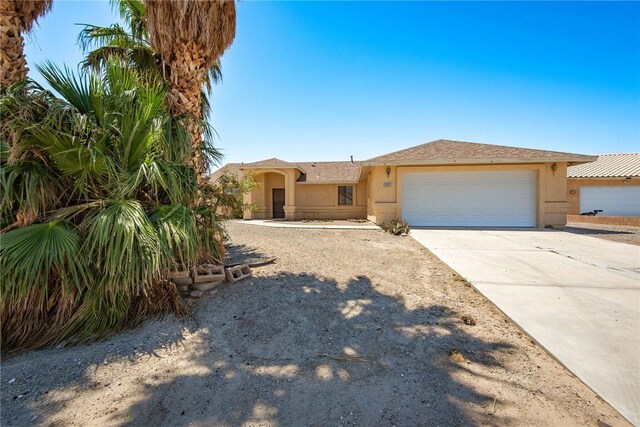 6045 S Klamath Loop, Fort Mohave, AZ 86426 - view of front of house featuring stucco siding, driveway, and an attached garage