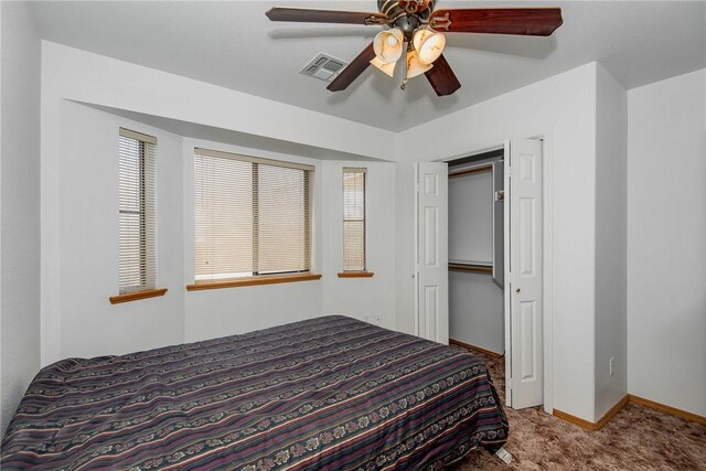 6045 S Klamath Loop, Fort Mohave, AZ 86426 - bedroom featuring carpet flooring, baseboards, a closet, and a ceiling fan