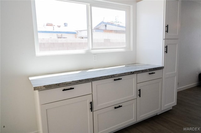 room details with baseboards and wood finished floors