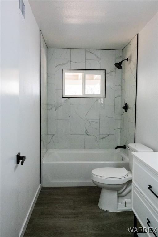 full bathroom featuring shower / bathing tub combination, wood finished floors, visible vents, and toilet