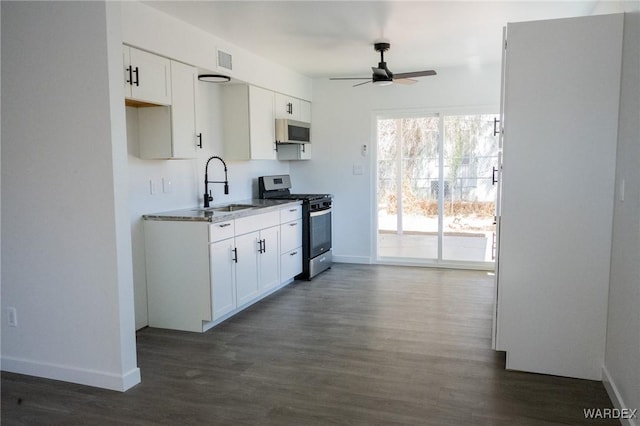 kitchen with a sink, visible vents, white cabinetry, a ceiling fan, and stainless steel gas stove