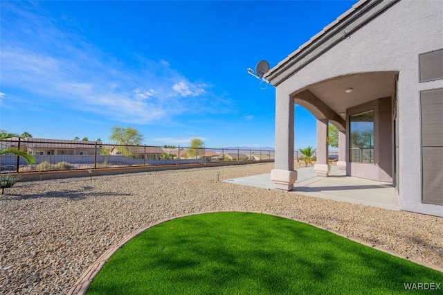 view of yard with a fenced backyard and a patio