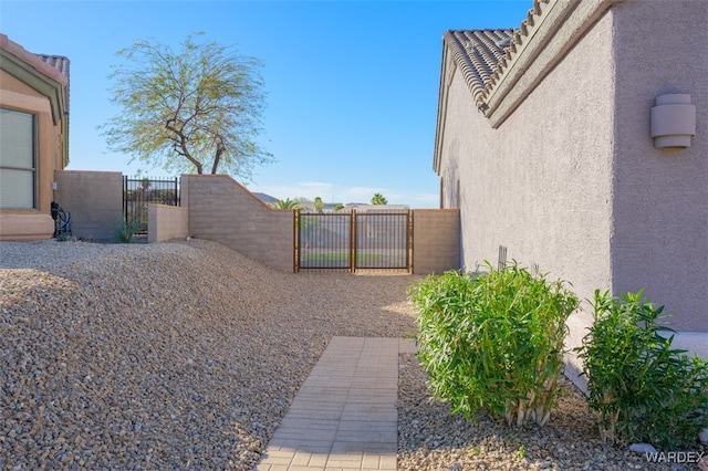 view of yard with fence and a gate