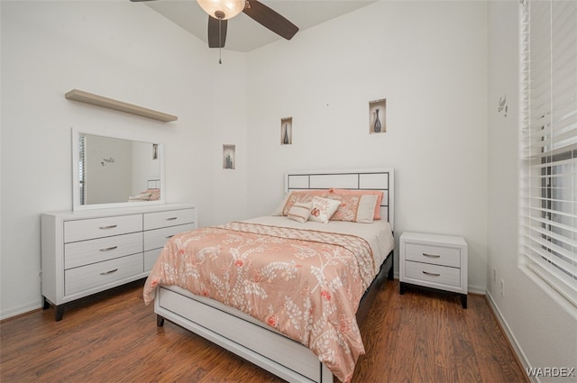 bedroom featuring baseboards and wood finished floors