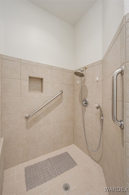 bathroom with a tile shower