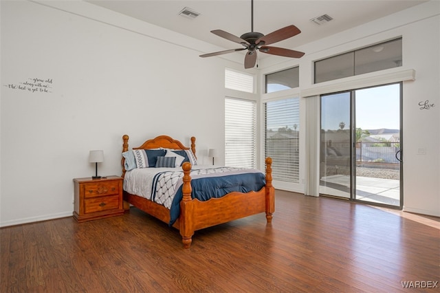 bedroom featuring access to outside, wood finished floors, and visible vents