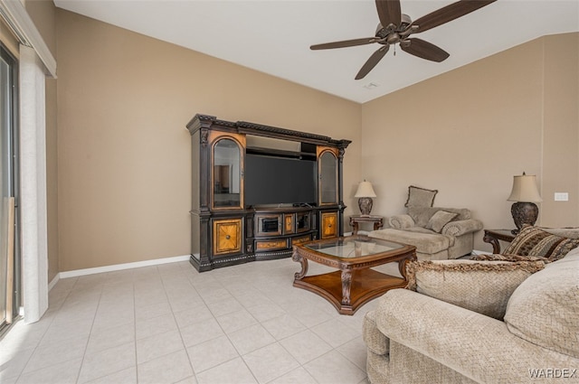 living room with light tile patterned floors, baseboards, and a ceiling fan