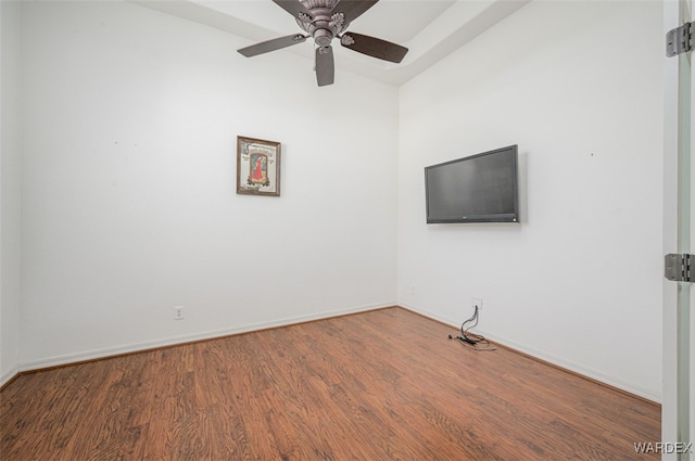 unfurnished room with a ceiling fan, baseboards, and wood finished floors