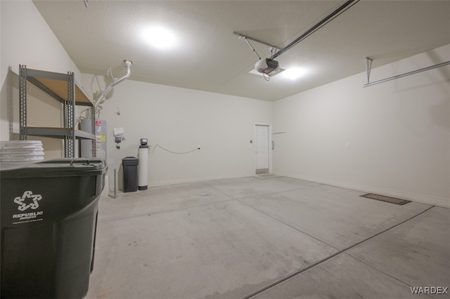 garage with baseboards and a garage door opener