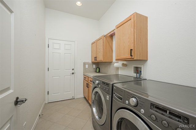 clothes washing area with recessed lighting, cabinet space, light tile patterned flooring, washer and dryer, and baseboards