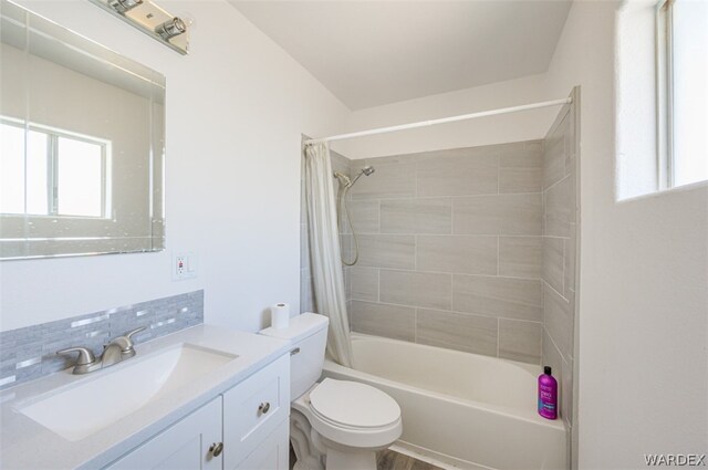 full bathroom with toilet, plenty of natural light, shower / tub combo with curtain, and vanity