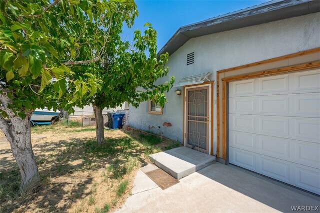 exterior space featuring a garage and stucco siding