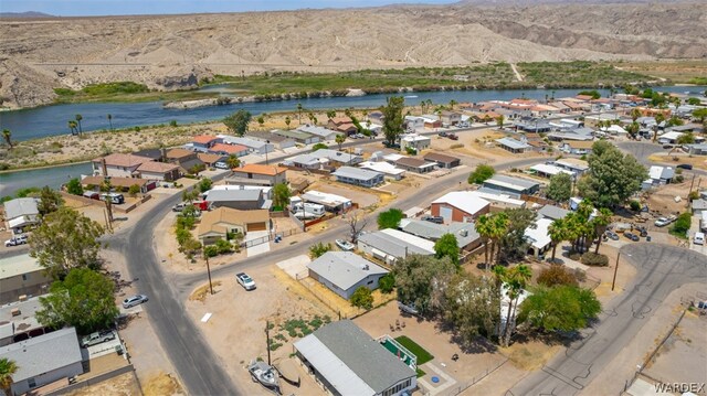 birds eye view of property with a residential view and a water and mountain view