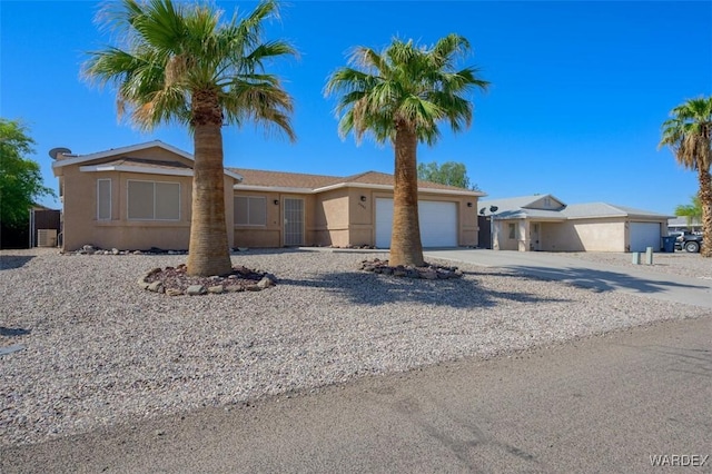 4804 S Baronsgate Way, Fort Mohave, AZ 86426 - view of front of house featuring an attached garage, stucco siding, and concrete driveway