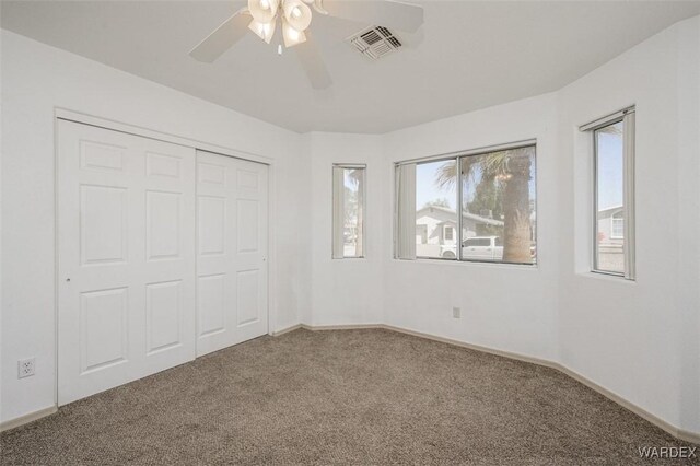 4804 S Baronsgate Way, Fort Mohave, AZ 86426 - unfurnished bedroom featuring a closet, carpet flooring, multiple windows, and visible vents