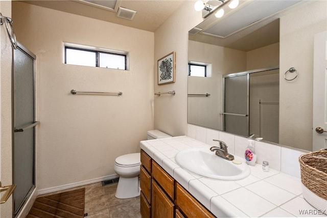 full bath featuring a healthy amount of sunlight, visible vents, vanity, and toilet