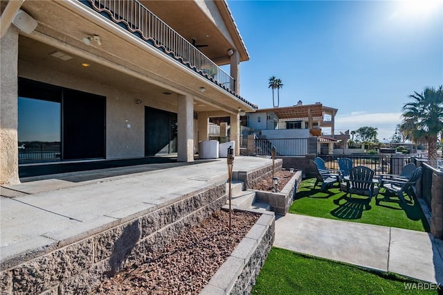 view of patio / terrace featuring a balcony and fence