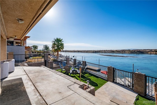 view of patio / terrace with a water view and a balcony