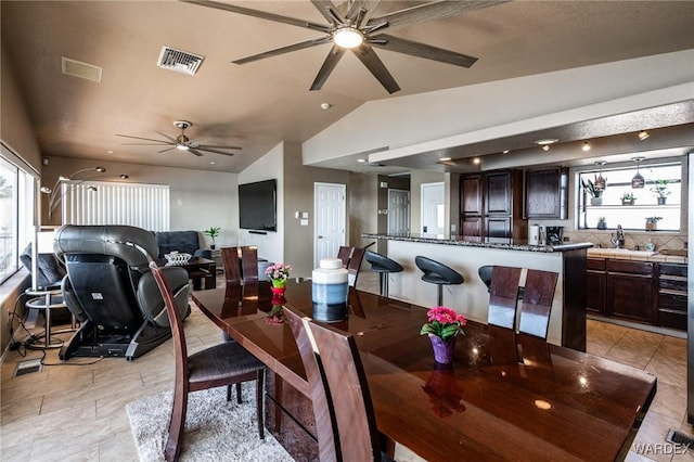 dining area with plenty of natural light, visible vents, and vaulted ceiling