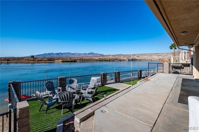 view of patio featuring a balcony and a water and mountain view