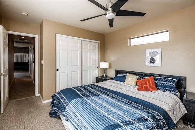 bedroom featuring carpet floors, a closet, ceiling fan, and baseboards