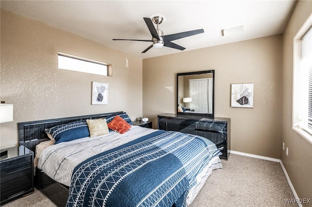 bedroom with light colored carpet, visible vents, ceiling fan, and baseboards