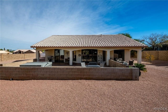 back of property featuring a patio, a fenced backyard, a tile roof, and stucco siding