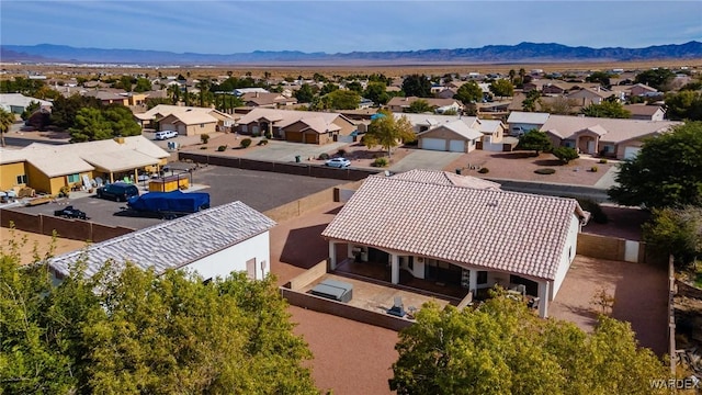 drone / aerial view featuring a residential view and a mountain view