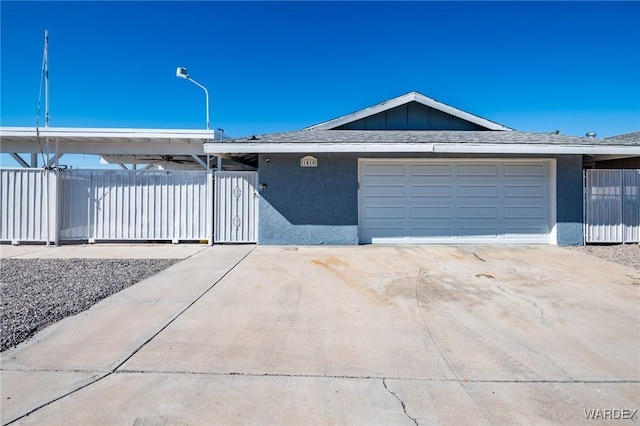 single story home featuring a garage, concrete driveway, roof with shingles, and stucco siding