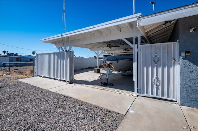 view of car parking with a carport, a gate, and fence