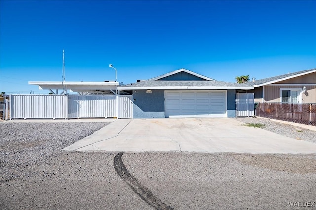 single story home with a garage, fence, concrete driveway, and stucco siding