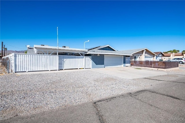 view of front facade with fence, driveway, an attached garage, and stucco siding