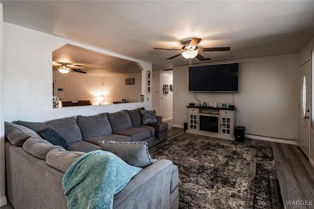 living room featuring a ceiling fan and wood finished floors