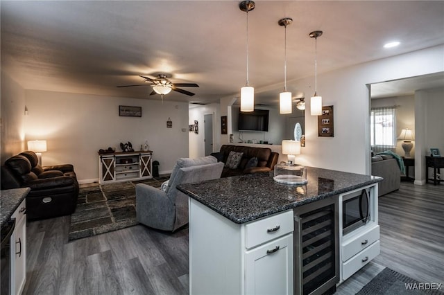 kitchen featuring beverage cooler, white cabinets, and open floor plan