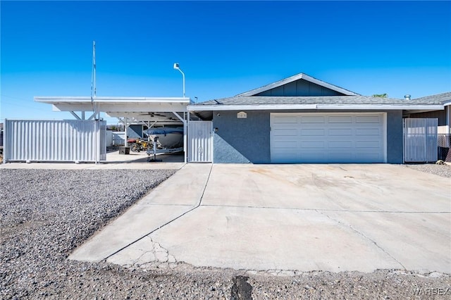 single story home featuring driveway, a shingled roof, an attached garage, and stucco siding