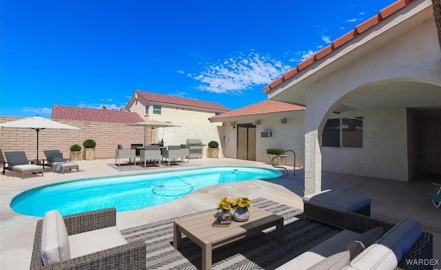 view of swimming pool featuring a fenced in pool, a grill, a patio, and outdoor lounge area