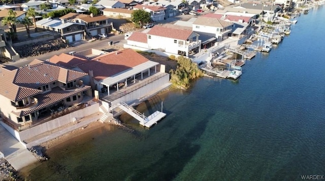 drone / aerial view featuring a water view and a residential view