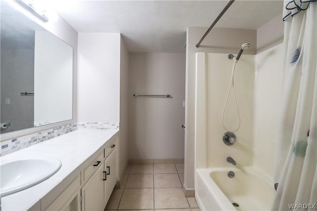 bathroom featuring baseboards, decorative backsplash, tile patterned floors, shower / bathtub combination with curtain, and vanity