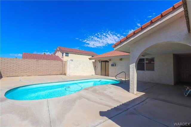 view of swimming pool featuring a patio area, fence, and a fenced in pool