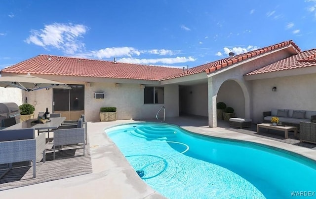 back of house featuring an outdoor pool, a patio area, an outdoor living space, and stucco siding