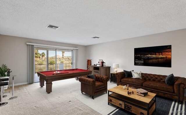 game room featuring light colored carpet, pool table, visible vents, and a textured ceiling