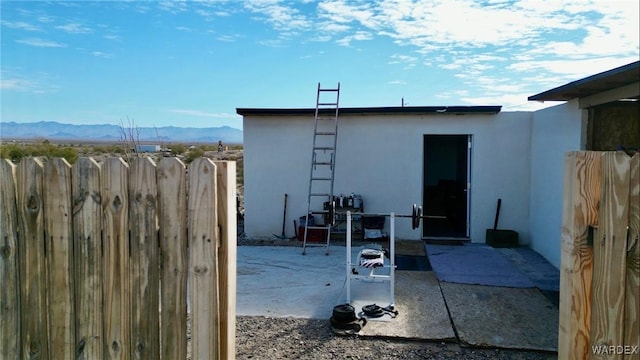 view of outdoor structure with fence and a mountain view