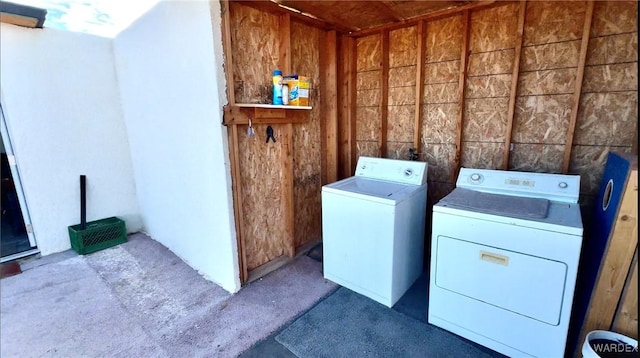 washroom featuring laundry area and washing machine and clothes dryer