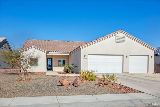 ranch-style house featuring an attached garage, stucco siding, concrete driveway, and a tiled roof