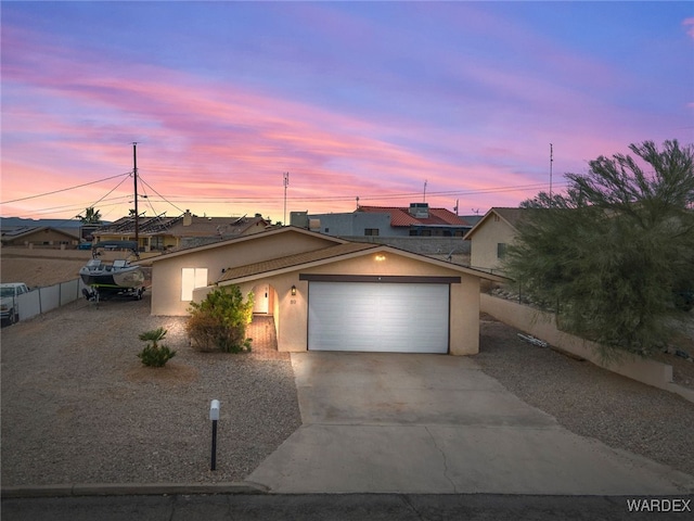 89 Keywester Dr, Lake Havasu, AZ 86403 - view of front of property featuring stucco siding, concrete driveway, a garage, and fence